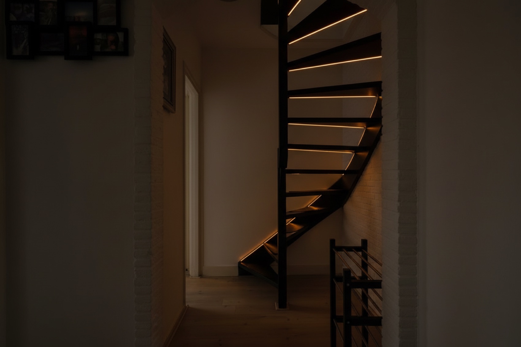 The spiral staircase in the dark, seen from the hallway